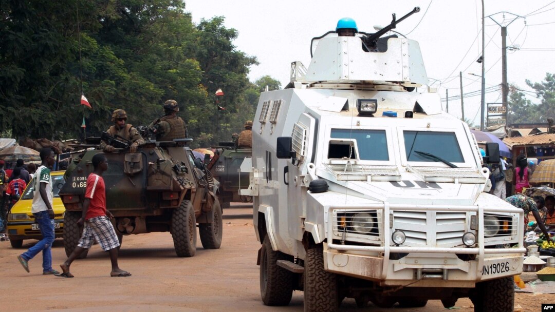 FILE - Police officers from the United Nations Multidimensional Integrated Stabilization Mission in the Central African Republic (MINUSCA) in an armored vehicle patrol a market in Bangui's Combattant district, Sept. 14, 2015.