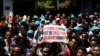 FILE - Eritrean refugees hold placards during a rally in support of a recent U.N. report that accused Eritrean leaders of committing crimes against humanity, outside the E.U. offices in Ramat Gan, Israel, June 21, 2016. 