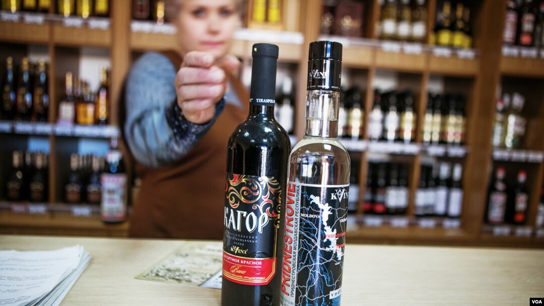 File - At a Kvint store, a saleswoman shows a vodka bottle. Scientists have used the spirit to send a text message (Vera Undritz for VOA)