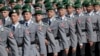 FILE - Soldiers attend an oath-taking ceremony of the German army at the Defense Ministry in Berlin, July 20, 2019.