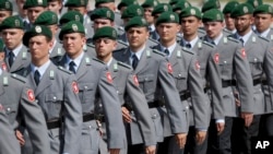 FILE - Soldiers attend an oath-taking ceremony of the German army at the Defense Ministry in Berlin, July 20, 2019.