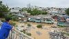 A man standing on Long Bien Bridge looks down at houses partially submerged in floodwaters in Hanoi on Sept. 10, 2024, after Typhoon Yagi hit Vietnam.