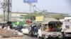 People flee the Hlaing Tharyar township in Yangon on March 16, 2021, as security forces continue a crackdown on protests in the area against the military coup. (Photo by STR / AFP)