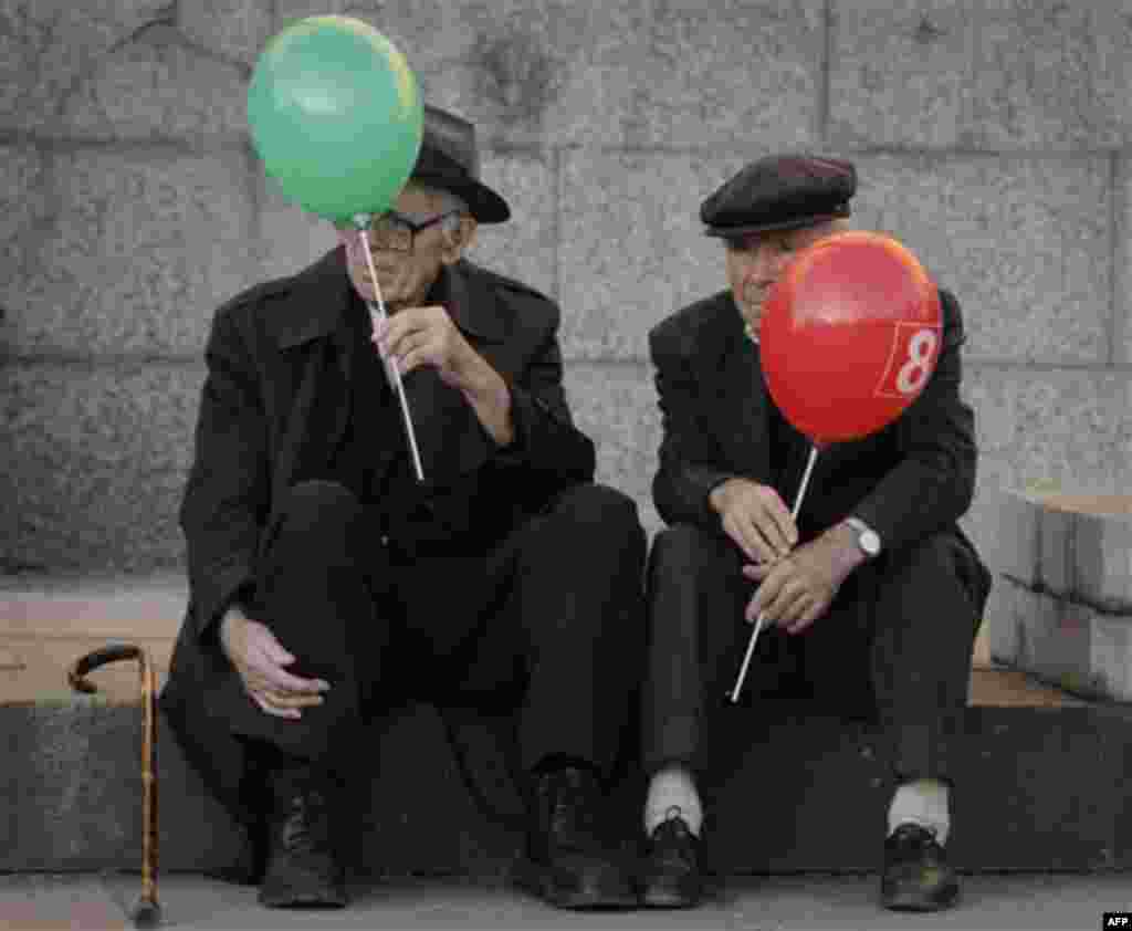 Supporters of Bulgaria's opposition Socialist Party hold balloons showing their presidential candidate Ivailo Kalfin's vote number during the last pre-election meeting of his campaign in Sofia, on Thursday, Oct. 20, 2011. The European Union's poorest memb