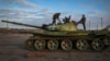 Ukrainian soldiers inspect a damaged Russian tank in the recently retaken village Chornobaivka near Kherson, Ukraine, Tuesday, Nov. 15, 2022. (AP Photo/Efrem Lukatsky)