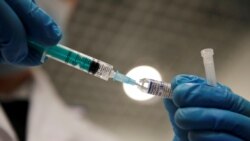 FILE - A medical worker holds a syringe with Sputnik V vaccine against the coronavirus disease at a vaccination center in St. Petersburg, Russia. Feb. 24, 2021.