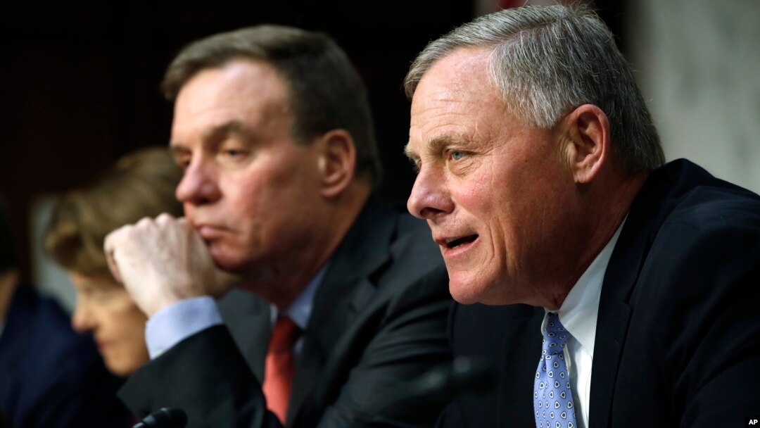 Senate Intelligence Committee chairman Sen. Richard Burr, R-NC, right, speaks next to Vice Chairman Sen. Mark Warner, D-VA., during a Senate Intelligence Committee hearing on Russian election activity and technology, Nov. 1, 2017, on Capitol Hill in Washington.