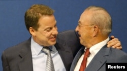 FILE - Ford Motor Company Chairman William Clay Ford Jr. (L) hugs his father, William Clay Ford Sr. (R), on June 16, 2003, in Dearborn, Michigan. The year 2003 marked the 100th anniversary of the company's founding.