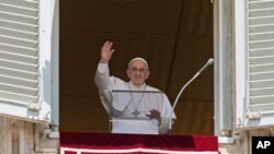 El Papa Francisco saluda a la multitud cuando llega a la oración del mediodía del Ángelus desde la ventana de su estudio con vista a la Plaza de San Pedro, en el Vaticano, el domingo 18 de julio de 2021.