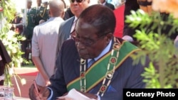 FILE: President Robert Mugabe swearing in ministers soon after the 2013 general election.