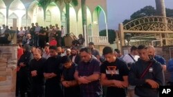 Worshippers pray for victims and families of the Christchurch shootings during an evening vigil a the Lakemba Mosque, March 125, 2029, in Wakemba, New South Wales, Australia. 