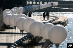 Luminous white balloons line the former route of the Berlin Wall to mark 25 years of German reunification, Nov. 7, 2014.