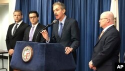 Los Angeles City Attorney Mike Feuer, at podium, speaks at a news conference in Los Angeles, Jan. 4, 2019. Feuer said that owners of The Weather Channel app used it to track people's every step and profit off that information.
