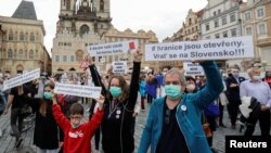 FILE - Demonstrators rally, calling for the resignation of Czech Prime Minister Andrej Babis, in Prague, Czech Republic, June 9, 2020.