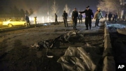 FILE - Afghan security forces inspect the site of a suicide attack near the Russian embassy in Kabul, Afghanistan. Conditions in Afghanistan are getting worse, 15 years into a war that few Americans talk about any more, Jan. 20, 2016.