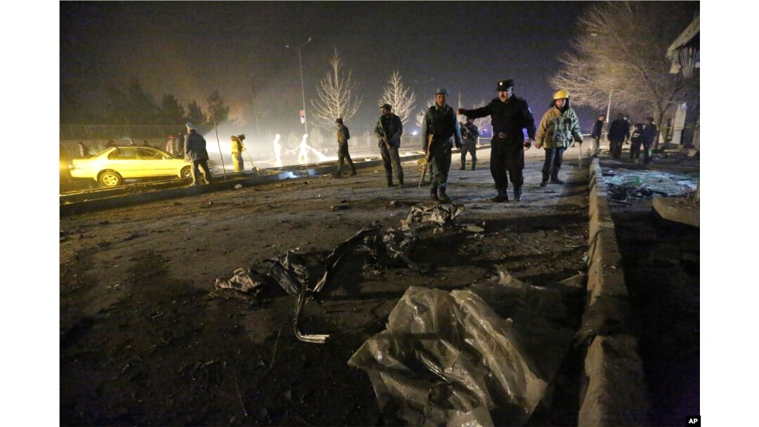 FILE - Afghan security forces inspect the site of a suicide attack near the Russian embassy in Kabul, Afghanistan, Jan. 20, 2016.