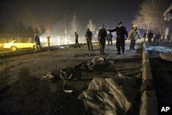 FILE - Afghan security forces inspect the site of a suicide attack near the Russian embassy in Kabul, Afghanistan. Conditions in Afghanistan are getting worse, 15 years into a war that few Americans talk about any more, Jan. 20, 2016.