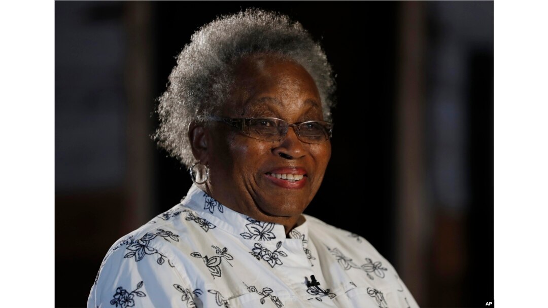 Emily Meggett is interviewed by The Associated Press at the National Museum of African American History in Washington, April 11, 2017, in front of a slave cabin on display.