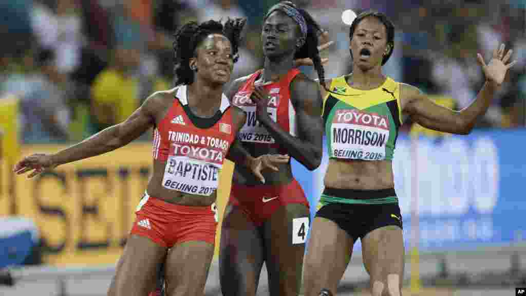 Trinidad and Tobago&#39;s Kelly-Ann Baptiste , left, collides with United States&#39; Tori Bowie and Jamaica&#39;s Natasha Morrison, right, after their women&#39;s 100m semifinal at the World Athletics Championships at the Bird&#39;s Nest stadium in Beijing, Monday, Aug. 24