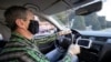 Montenegro, Podgorica, A taxi driver wears a protective mask and gloves after government ban all public transport due first two registred cases of coronavirus