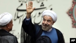 Iran's new president, Hassan Rouhani, waves after his swearing-in at the parliament in Tehran, August. 4, 2013.