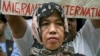 FILE - A Filipino Muslim woman joins the picket led by a migrant workers group for human rights at the embassy of the United Arab Emirates (UAE) in Manila.