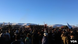 Water protectors celebrate the decision of the Army Corps to deny the building of the Dakota Access Oil Pipeline through their and sacred Sioux land (E. Sarai/VOA)