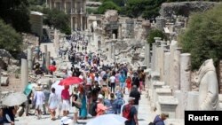 FILE - Tourists visit the ancient city of Ephesus near Izmir in the western Aegean region, Turkey, Aug. 5, 2018.