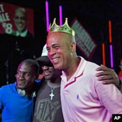 Haiti's presidential candidate Michel Martelly poses for a photo with supporters at a campaign rally in Gonaives, Mar 11 2011