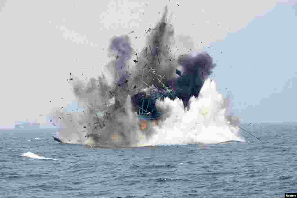 A foreign fishing boat confiscated for illegal fishing is blown up by the Indonesian Navy off of Lemukutan Island, West Kalimantan, Indonesia in this photo taken by Antara Foto.