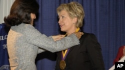 Senator Hillary Rodham Clinton receives her medal after being named to the National Women's Hall of Fame in Seneca Falls, N.Y.