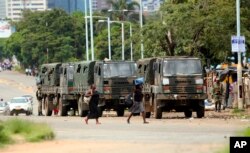 Zimbabwe soldiers are placed where police are clashing with protestors over fuel hikes in Harare, Jan. 14, 2019.