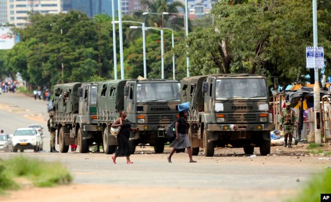 Zimbabwe soldiers are placed where police are clashing with protestors over fuel hikes in Harare, Jan. 14, 2019.