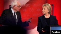 Democratic U.S. presidential candidate Senator Bernie Sanders (L) speaks directly to former Secretary of State Hillary Clinton as they discuss issues during the Democratic presidential candidates debate at the University of New Hampshire. Many noted the tone of the debate had sharpened.