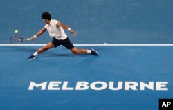 South Korea's Chung Hyeon makes a backhand return to Serbia's Novak Djokovic