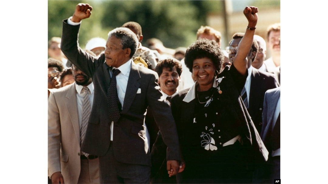 FILE – Nelson Mandela and wife Winnie Madikizela-Mandela raise clenched fists as they walk hand-in-hand upon his release from prison in Cape Town, South Africa, Feb. 11, 1990.