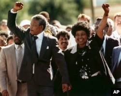 FILE – Nelson Mandela and wife Winnie Madikizela-Mandela raise clenched fists as they walk hand-in-hand upon his release from prison in Cape Town, South Africa, Feb. 11, 1990.