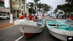 Fishermen move their boats, normally moored in the Gulf of Mexico, onto a coastal road to protect them ahead of the arrival of Tropical Storm Franklin, in the port city of Veracruz, Mexico, Aug. 9, 2017.