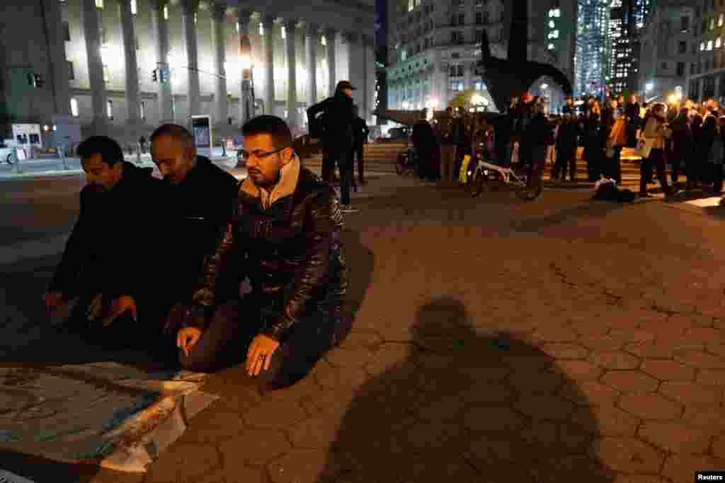 Muslims pray following a candlelight vigil for victims of the pickup truck attack in New York City, Nov. 1, 2017.