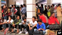 Crowds of people wait for trains to arrive before they can make hour-long journeys back to their hometowns.