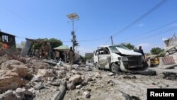 索马里警察在爆炸事发现场检查残骸。