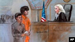 FILE - This courtroom sketch depicts Boston Marathon bombing suspect Dzhokhar Tsarnaev standing with his lawyer Judy Clarke (L) before Magistrate Judge Marianne Bowler (R) during his arraignment in federal court in Boston, July 10, 2013.