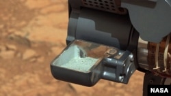 This image from NASA's Curiosity rover shows the first sample of powdered rock extracted by the rover's drill. (NASA/JPL-Caltech/MSSS)