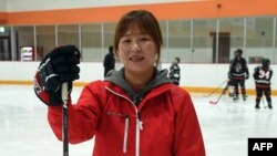 Former North Korean ice hockey player Hwangbo Young, center, coaches an ice hockey class for children at an ice rink in Seoul. When the North and South Korean women's hockey teams clash in a rare match this week, defector-turned-star-player Hwangbo Young will cheer for the country that has labeled her a traitor.