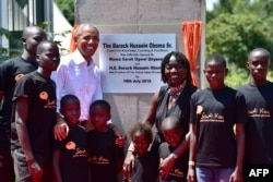 Former US President, Barack Obama (2L) poses for a photograph with local young beneficiaries on July 16, 2018 during the opening of the Sauti Kuu Resource Centre, founded by his half-sister, Auma Obama (3R) at Kogelo in Siaya county, western Kenya.