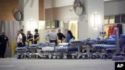 FILE - Emergency personnel wait with stretchers at the emergency entrance to Orlando Regional Medical Center hospital for the arrival of patients from the scene of a fatal shooting at Pulse Orlando nightclub in Orlando, Florida, on June 12, 2016. 