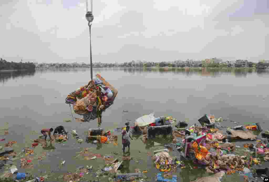 Workers remove idols of elephant-headed Hindu god Ganesha that were immersed in Saroornagar Lake on the final day of Ganesh Chaturthi festival in Hyderabad, India.