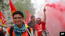 Union members march during a rally in Paris, May 17, 2016. Truckers blocked French highways and workers marched through city streets Tuesday to protest a new labor bill they claim is unfriendly to workers.
