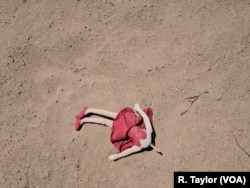 An abandoned doll lay on the sand in San Luis, Arizona, less than a hundred meters from the U.S.-Mexico barrier.