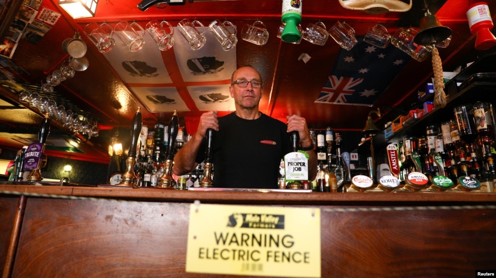 Johnny McFadden, 61, poses for a photo at the bar area of The Star Inn. An electric fence has been installed at the bar area to ensure customers are socially distanced in St Just, Cornwall, Britain July 14, 2020. (REUTERS/Tom Nicholson)